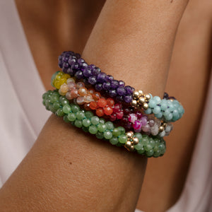 ultimate rainbow and gold beaded bracelet on model worn with two other bracelets