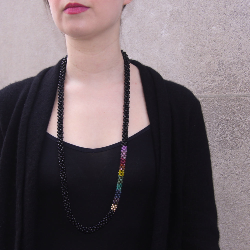 rainbow, black onyx and gold beaded necklace on model