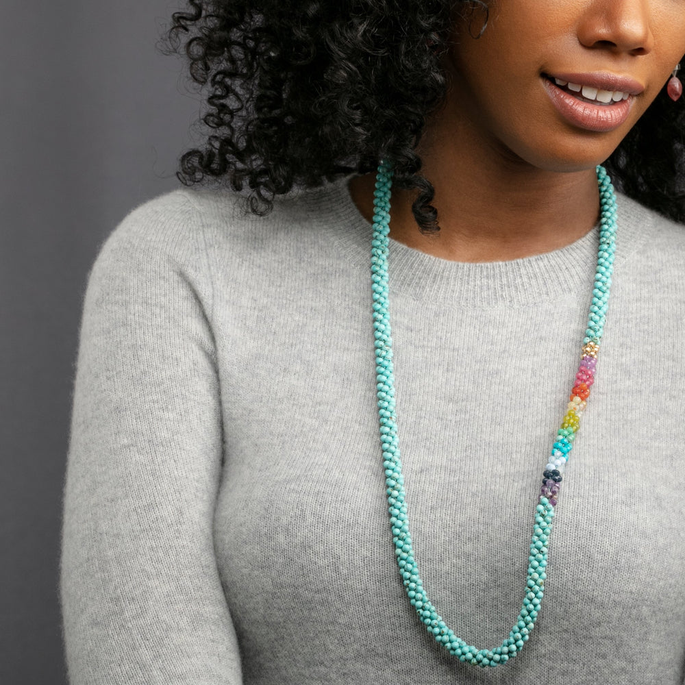 rainbow, turquoise and gold beaded necklace on model