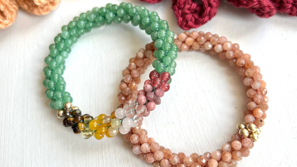 two handmade beaded gemstone bracelets in green, peach, brown and pink