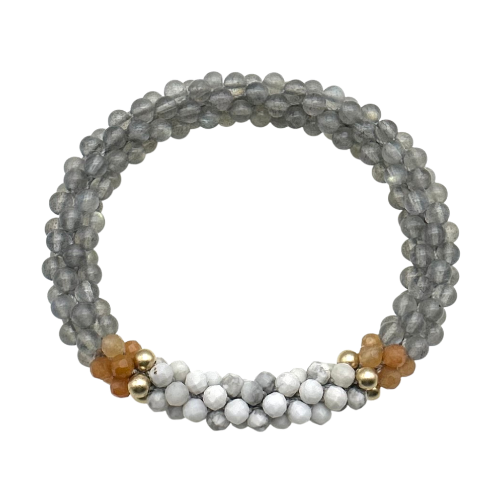 Handmade beaded gemstone bracelet in grey with orange and white accents on a white background