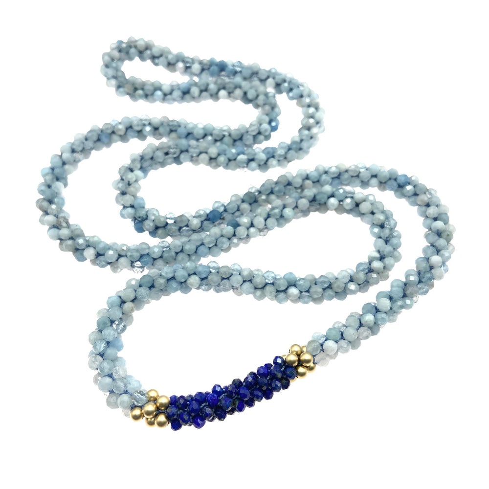 aquamarine, lapis and gold beaded gemstone necklace on white background