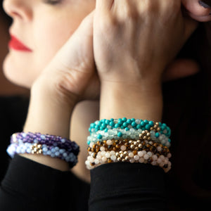 stacks of handmade beaded gemstone polka dot bracelets worn on model