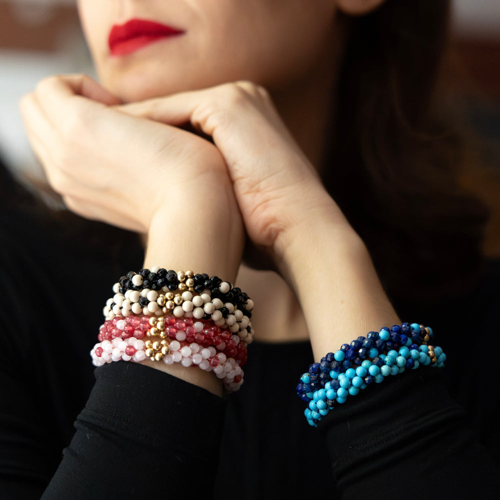 stacks of handmade beaded gemstone "polka dot" bracelets worn on model