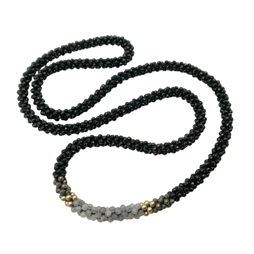 Handmade black beaded gemstone necklace with gold and gray accents on a white background