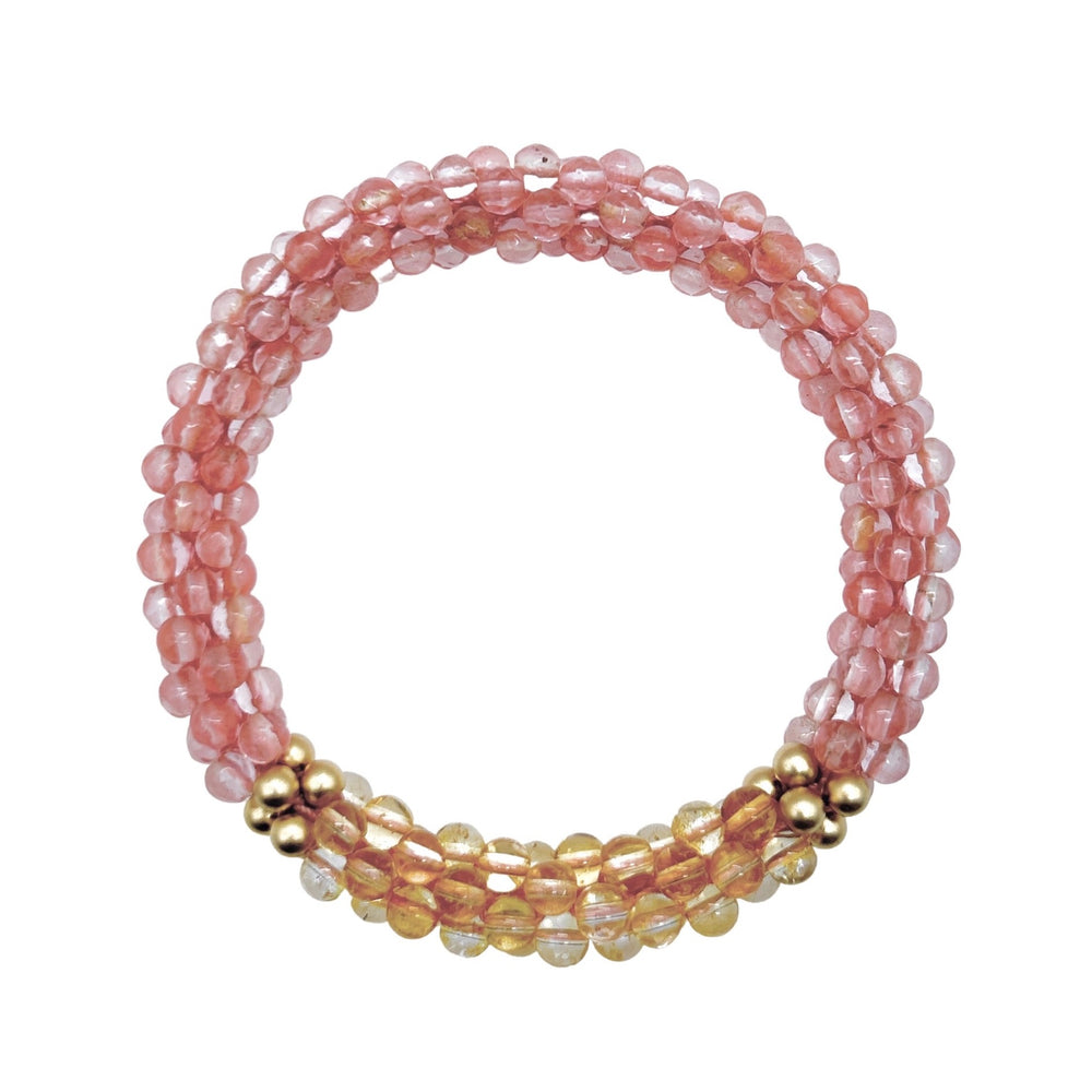 cherry quartz, citrine and gold beaded gemstone bracelet on white background