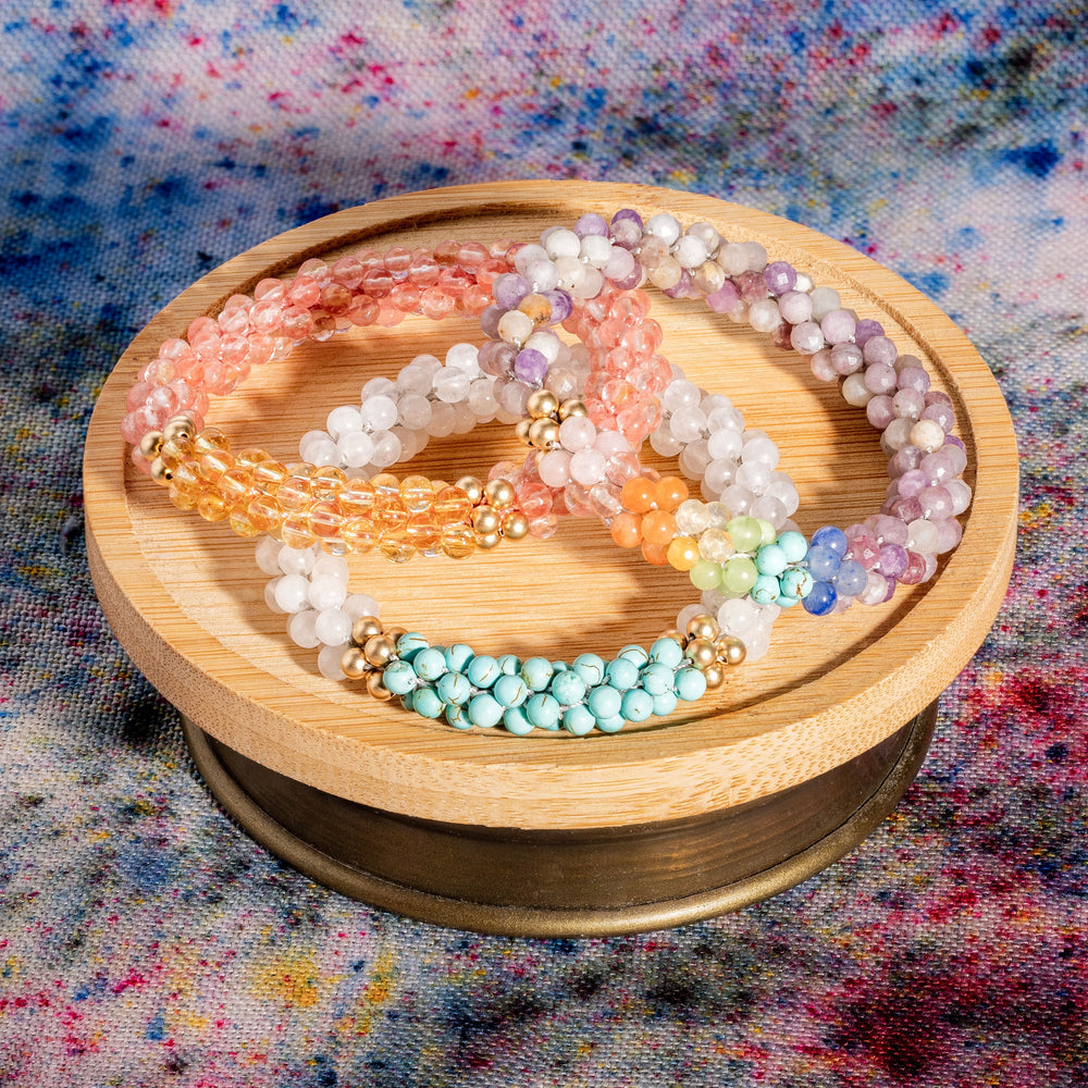 three beaded gemstone bracelets in pastel colors