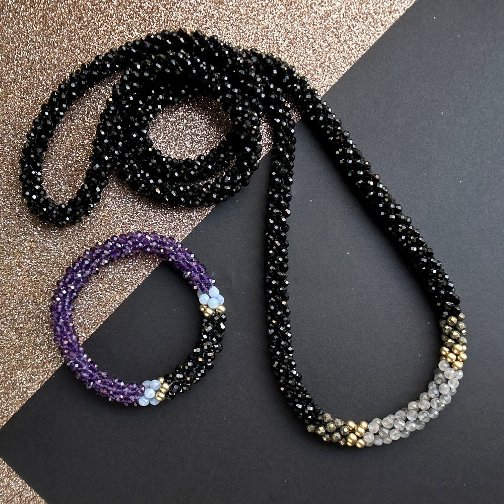 Handmade beaded gemstone necklace and bracelet on a two tone background