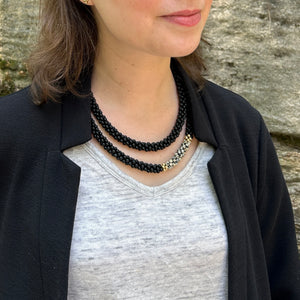black onyx, dalmatian jasper and gold beaded gemstone necklace on model worn doubled