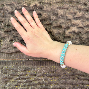 pride collection handmade beaded gemstone bracelet in turquoise, white and gold on wrist