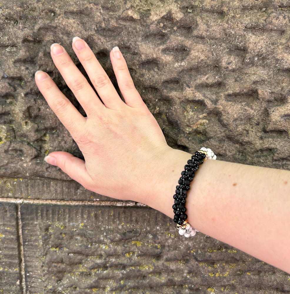 pride collection handmade beaded gemstone bracelet in black, white and gold on wrist