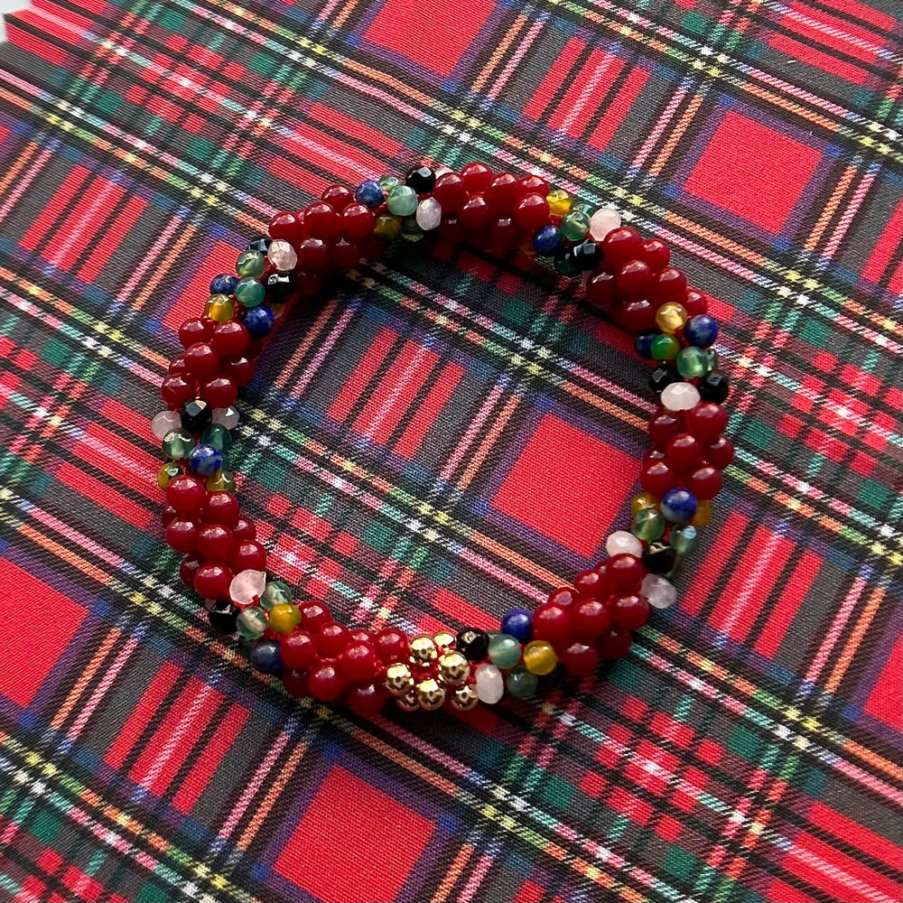 
            
                Load image into Gallery viewer, tartan-inspired beaded gemstone bracelet in royal stewart colorway on matching plaid fabric
            
        