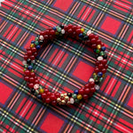 tartan-inspired beaded gemstone bracelet in royal stewart colorway on matching plaid fabric