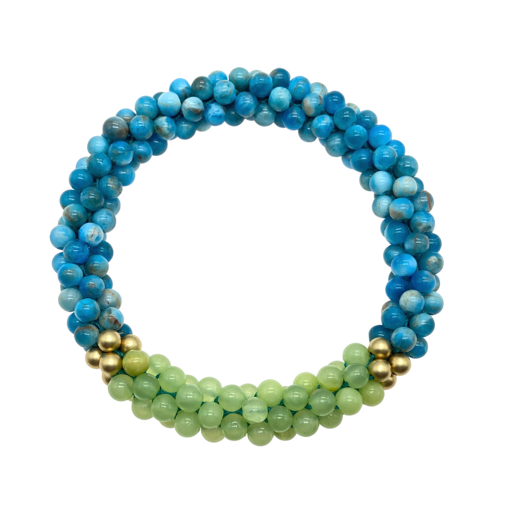 apatite, green calcite and gold bracelet on white background