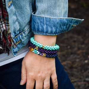 
            
                Load image into Gallery viewer, rainbow, lapis and gold beaded bracelet on model worn with two other bracelets
            
        