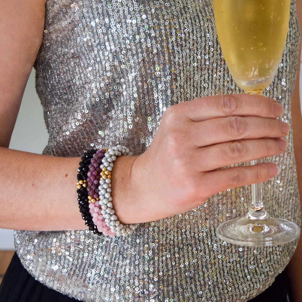 rose quartz, lepidolite and gold bracelet on model worn with two other bracelets
