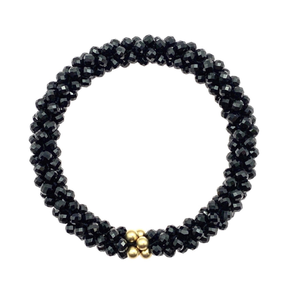 black spinel and gold beaded gemstone bracelet on white background