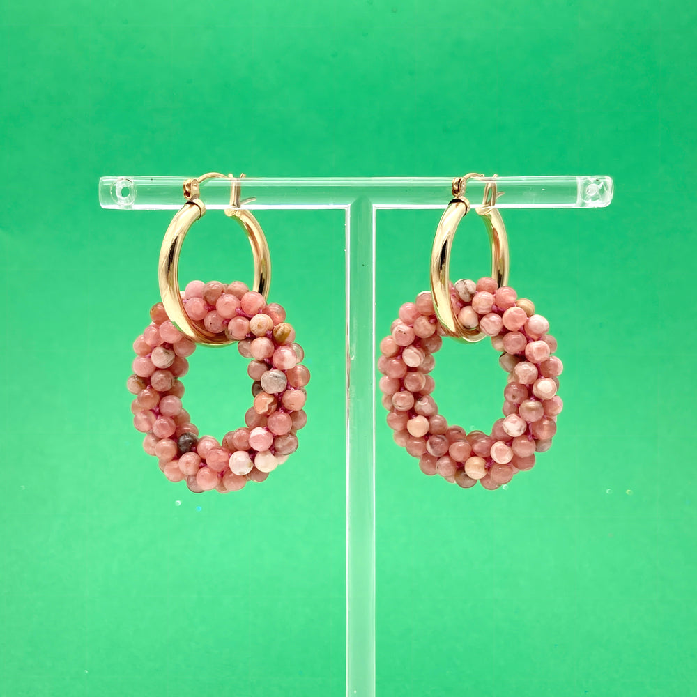 rhodonite beaded gemstone earrings with gold hoops on green background