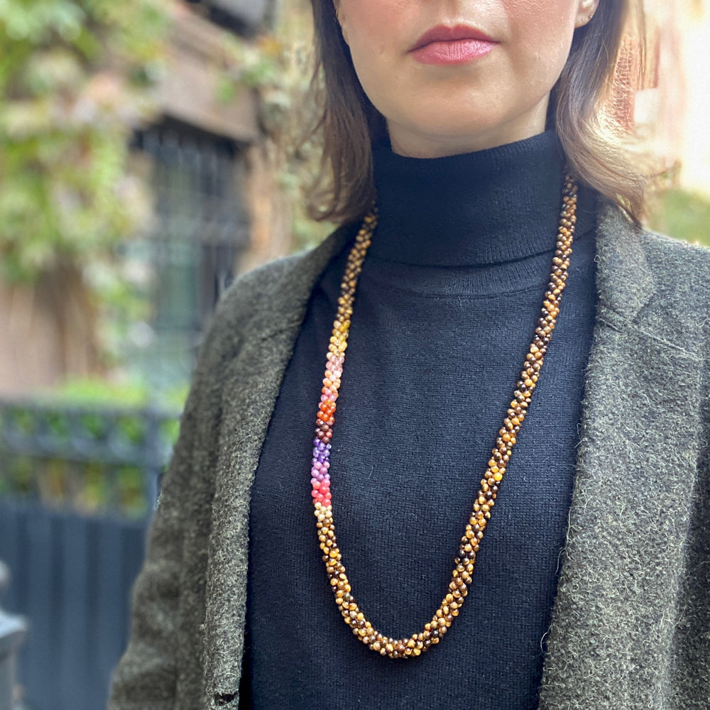 fiery red ombre, tiger eye and gold beaded necklace on model