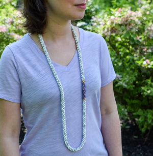 howlite, purple jade and gold beaded necklace on model worn long