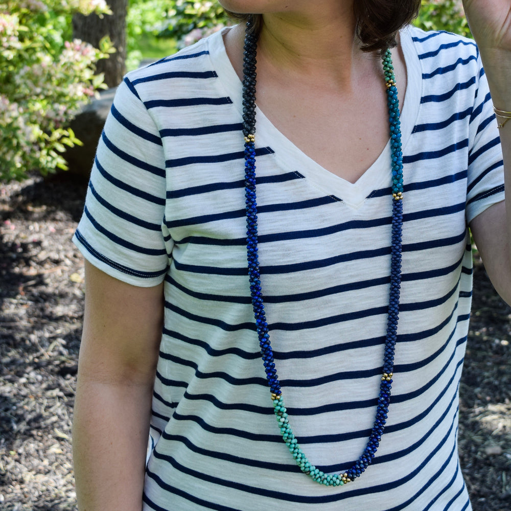 lapis, moss opal and gold necklace on model worn long