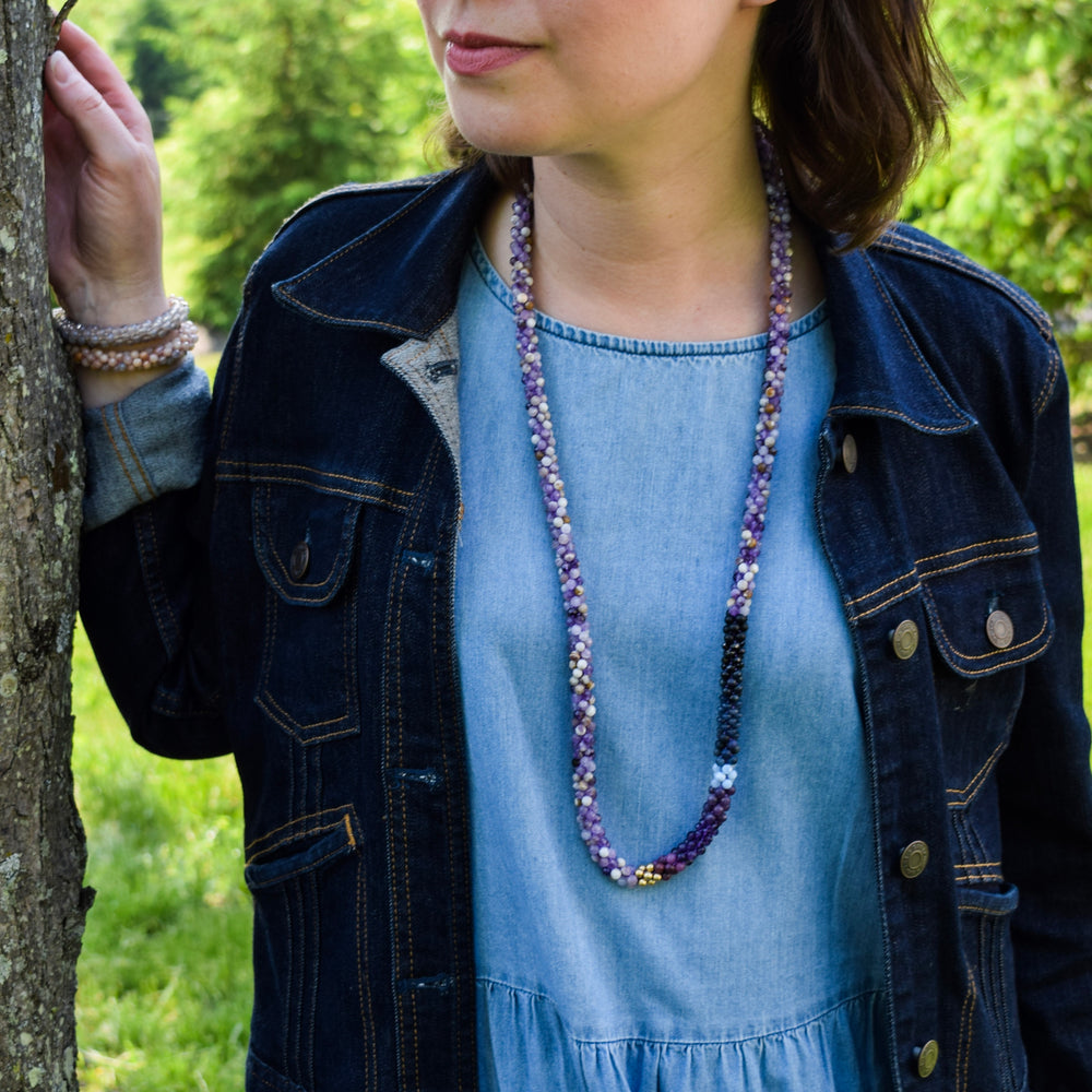 rich purple ombre, amethyst and gold beaded necklace on model