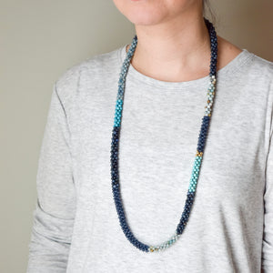 shades of blue color block beaded necklace on model