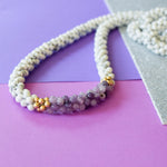 detail of howlite, purple jade and gold beaded necklace