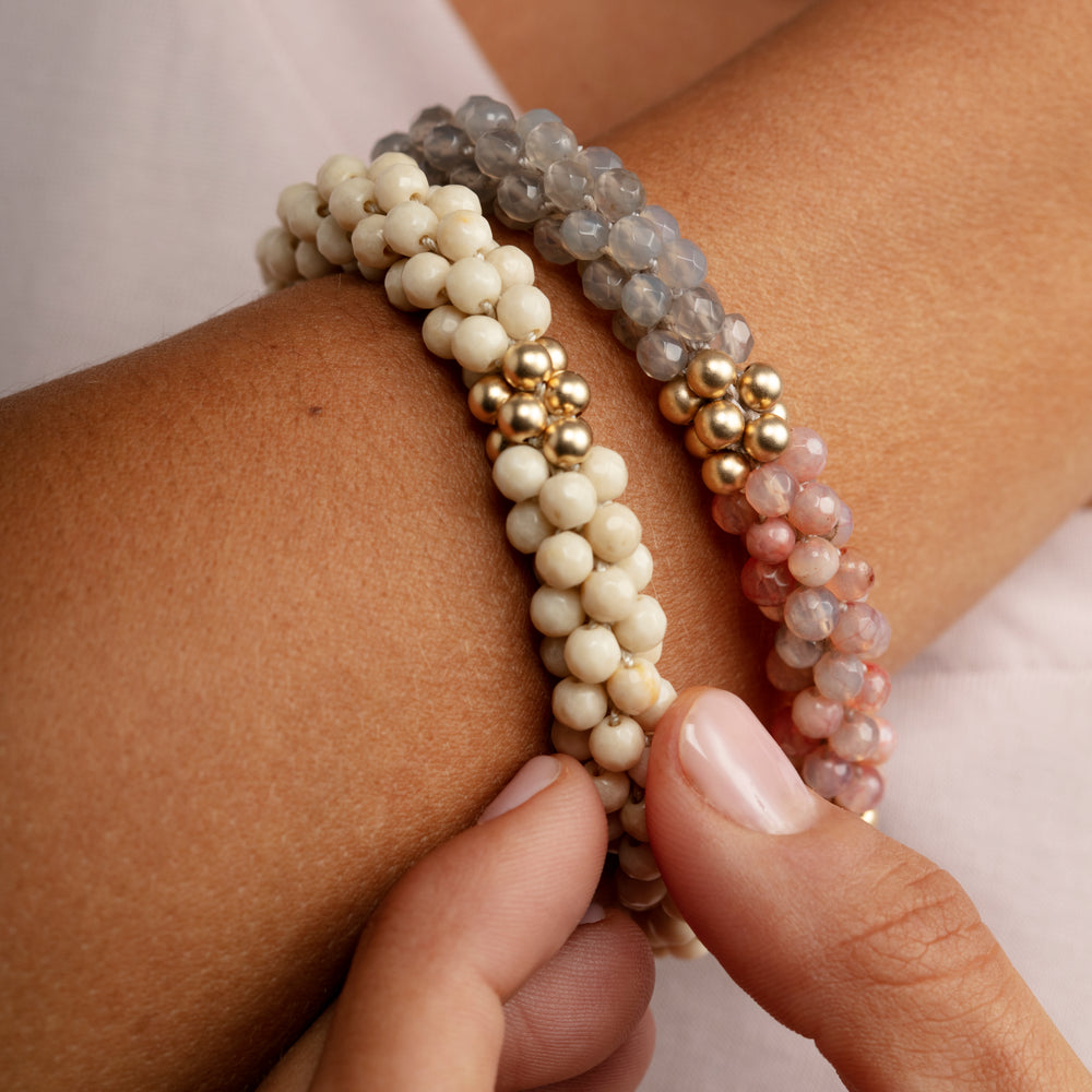
            
                Load image into Gallery viewer, grey onyx, peach agate and gold bracelet on model worn with another bracelet
            
        