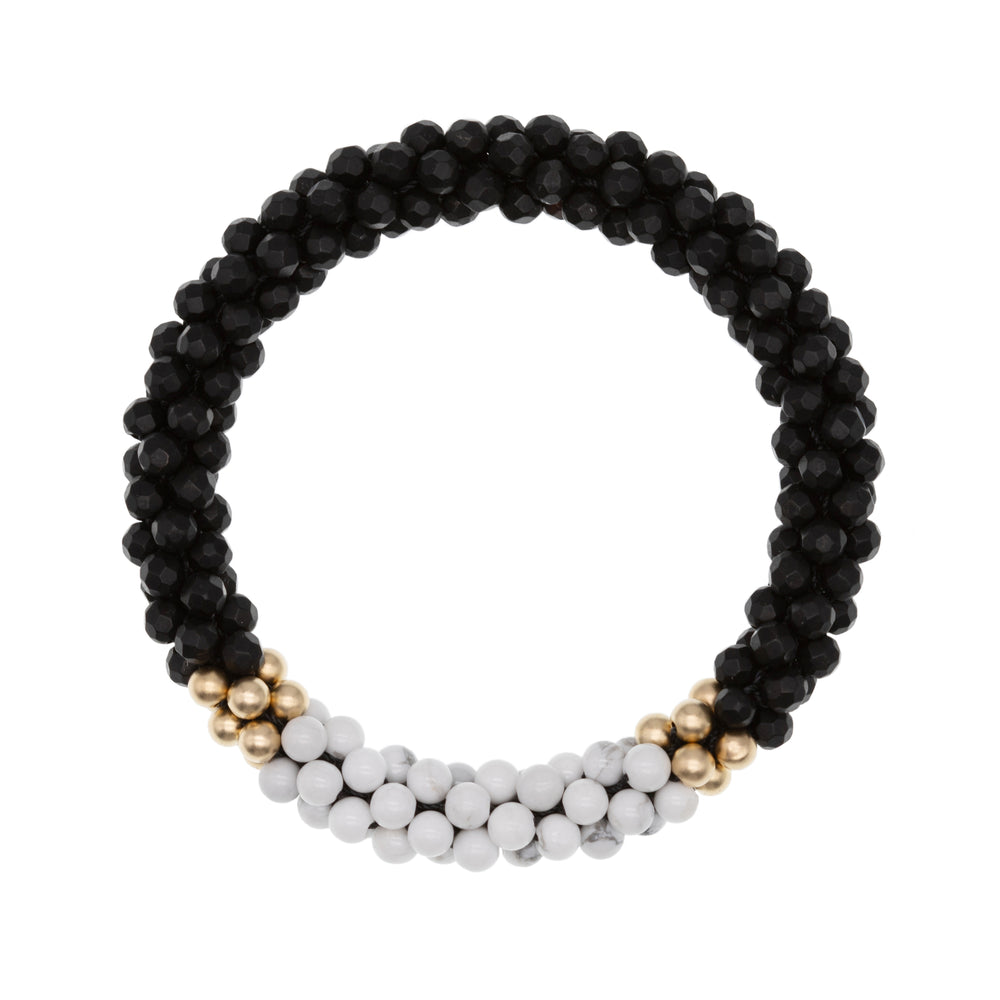 beaded gemstone bracelet: matte black onyx, howlite and gold on white background