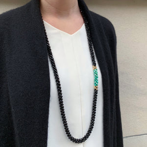 black spinel, moss opal and gold beaded necklace on model worn long