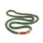 beaded gemstone necklace: jade, carnelian and gold on white background