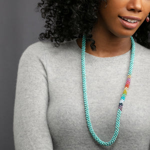 
            
                Load image into Gallery viewer, rainbow, turquoise and gold beaded necklace on model
            
        